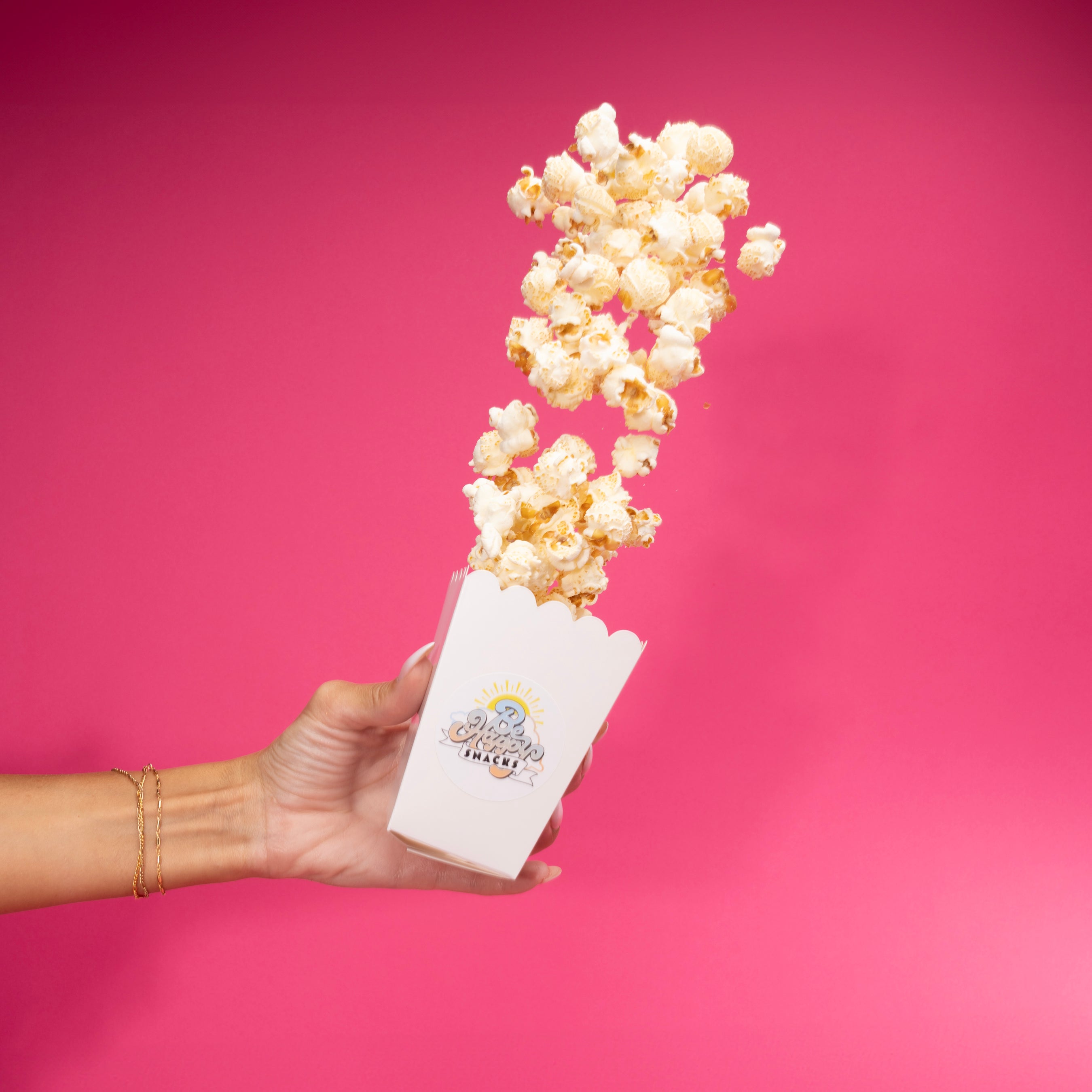 Popcorn pouring out of a popcorn cup